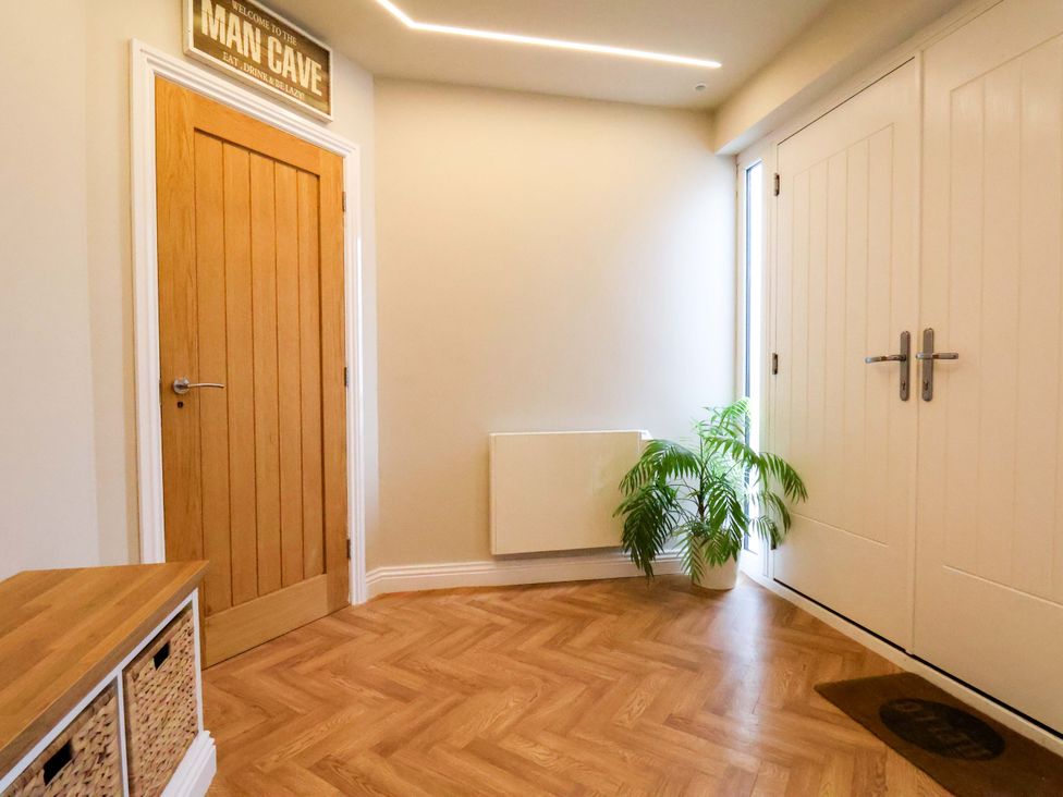 A hallway with a door and plant at 23 Main Street