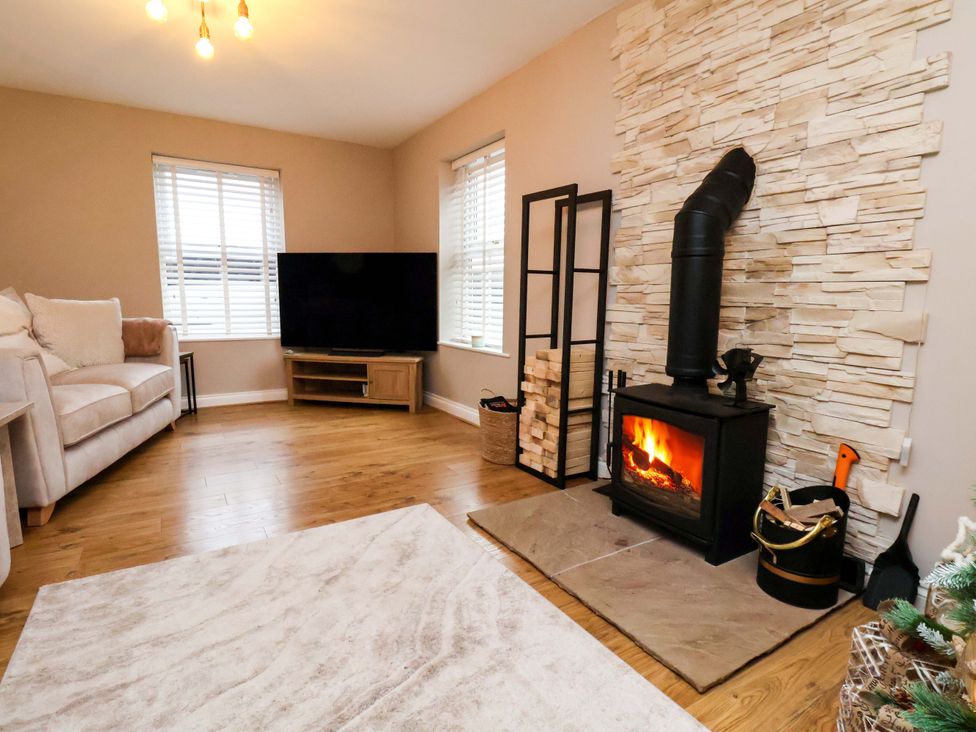 A living room with a fireplace and sofa at 23 Main Street