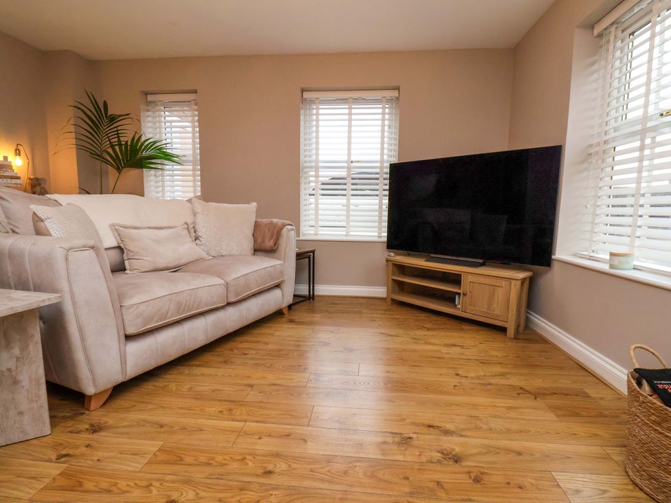 A living room with a sofa and television at 23 Main Street