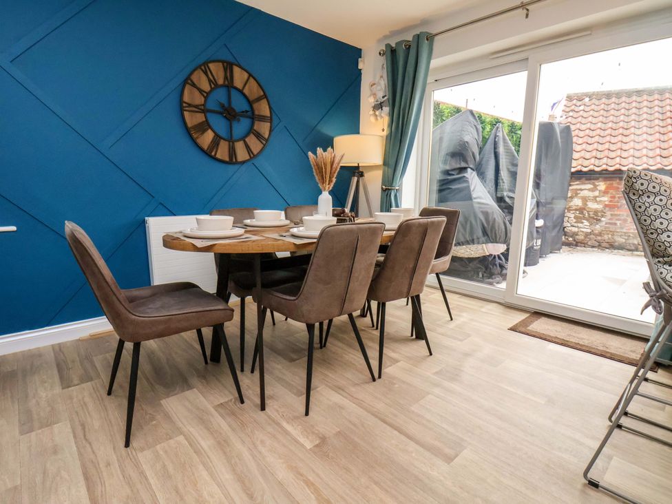 A dining area with a table and chairs at 23 Main Street 