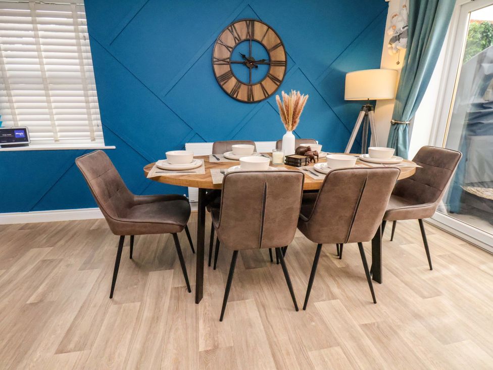 A dining room with a table and chairs at 23 Main Street