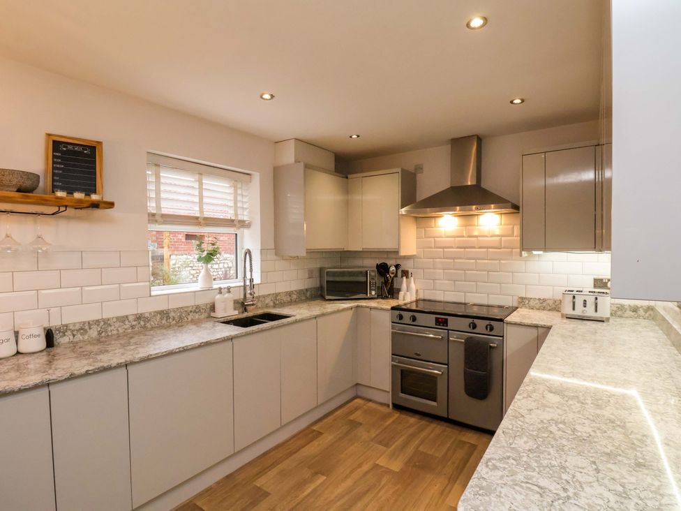 A kitchen with a stainless steel oven and granite countertops at 23 Main Street in 