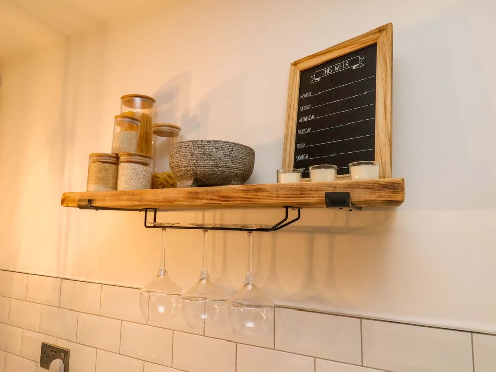 A kitchen shelf with jars and wine glasses at 23 Main Street