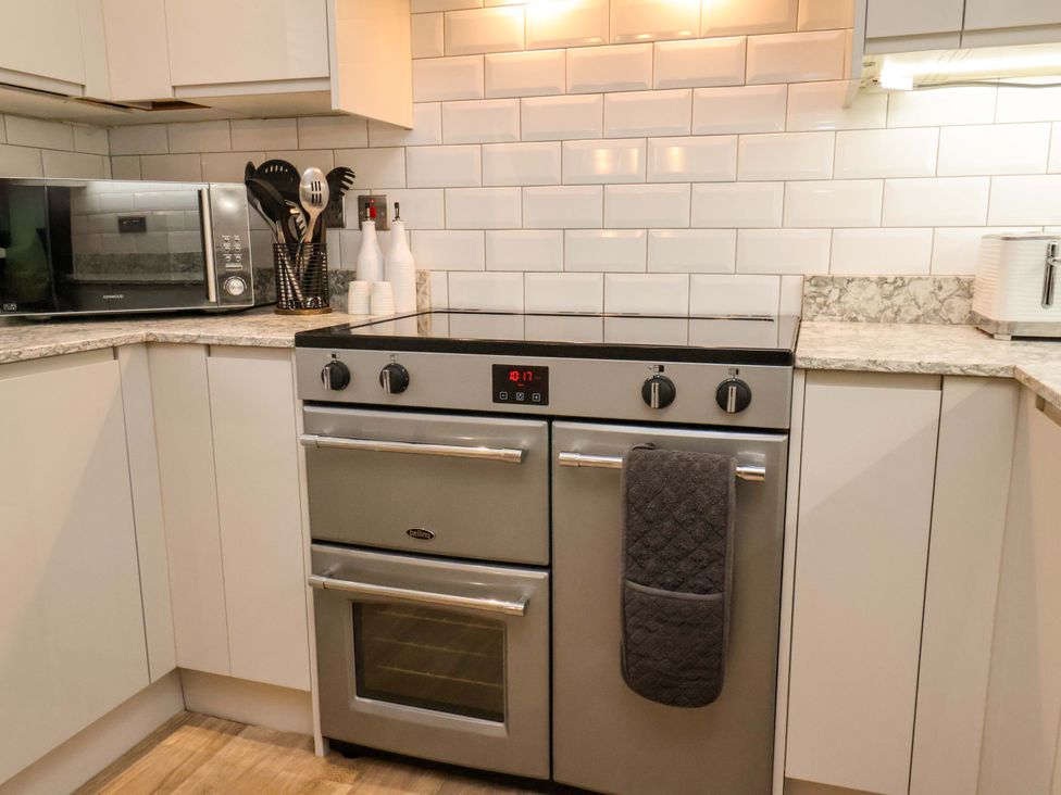 A kitchen with a stove and microwave at 23 Main Street
