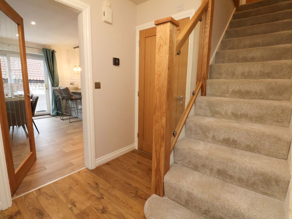 A hallway with stairs and a door at 23 Main Street 