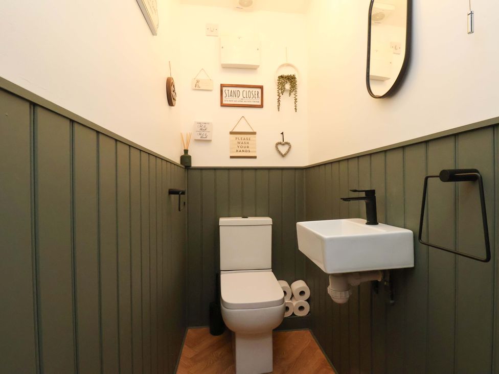 A bathroom with a toilet and wash basin at 23 Main Street