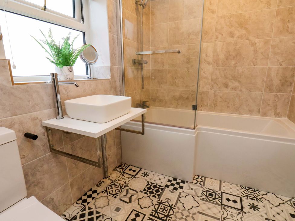 A bathroom featuring a sink and bathtub at 23 Main Street