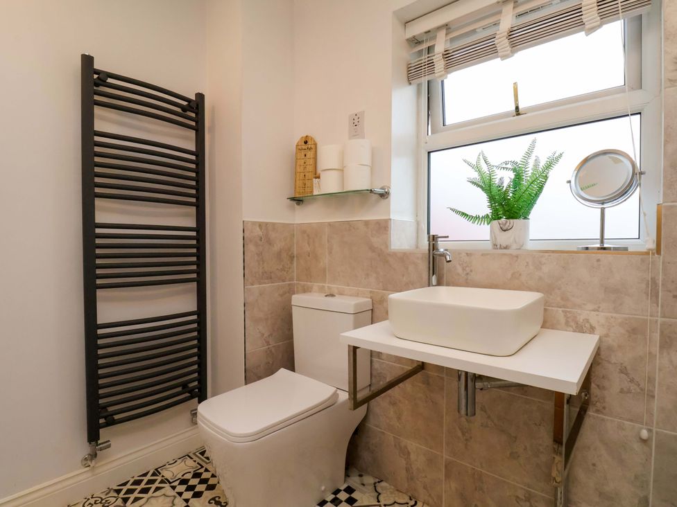 A bathroom with toilet and sink at 23 Main Street