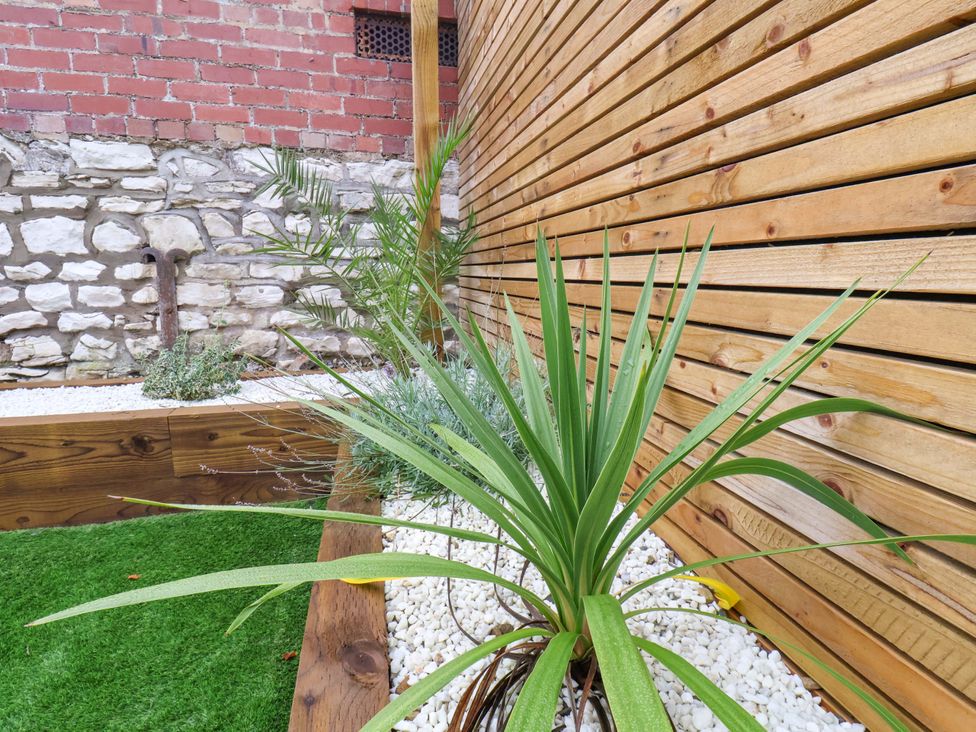 A garden with plants and gravel at 23 Main Street