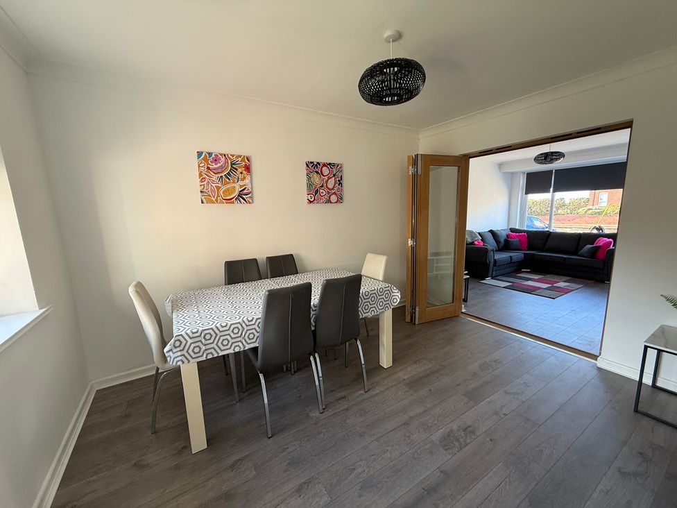 A dining room with a table and chairs at Beach Side Bungalow