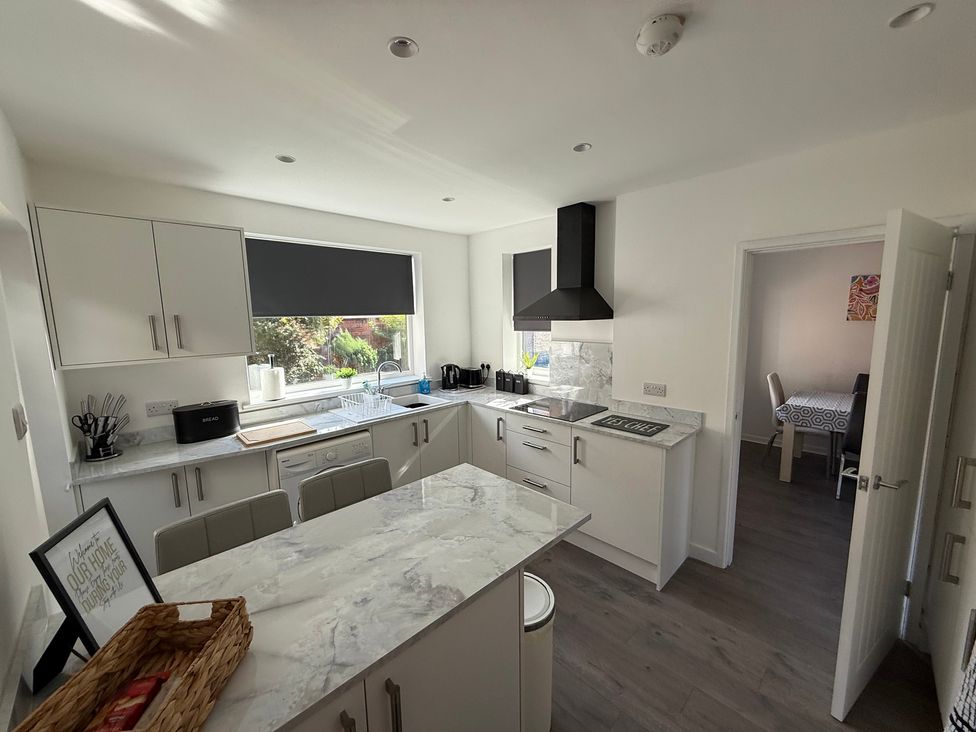 A kitchen with countertops and appliances at Beach Side Bungalow
