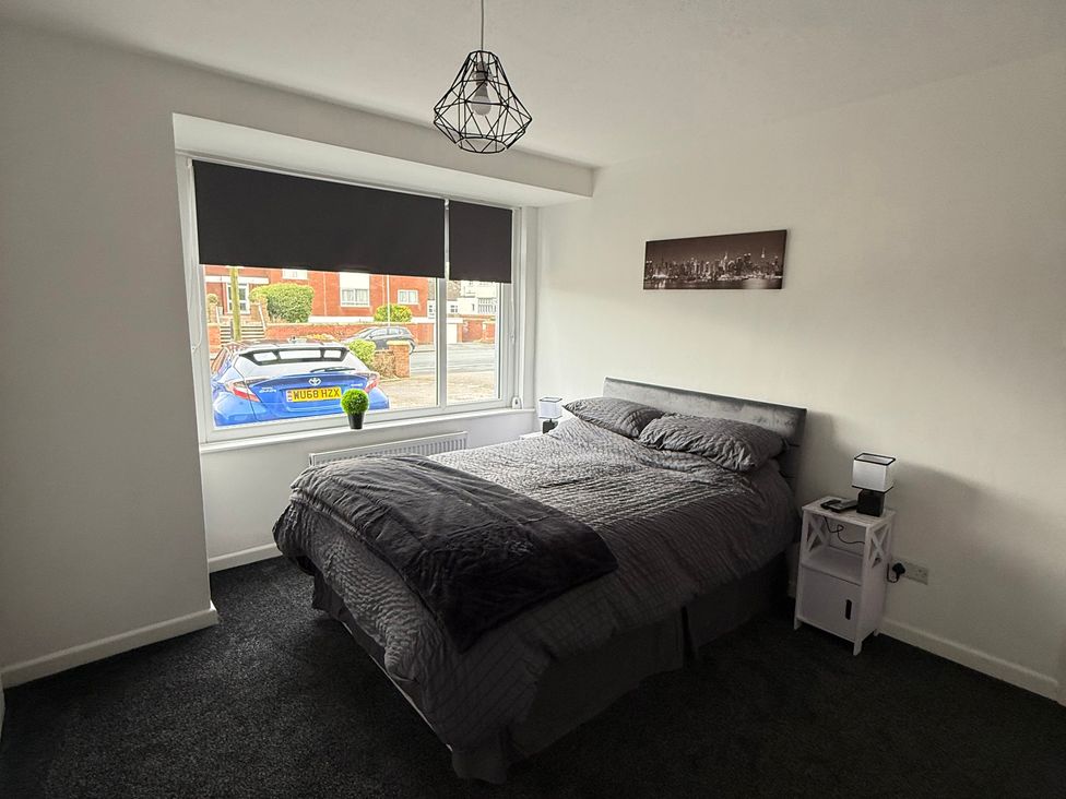 A bedroom with a bed and window at Beach Side Bungalow