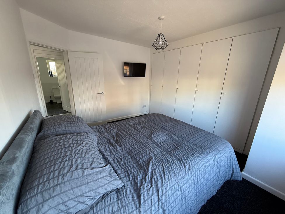 A bedroom with a bed and wardrobe at Beach Side Bungalow