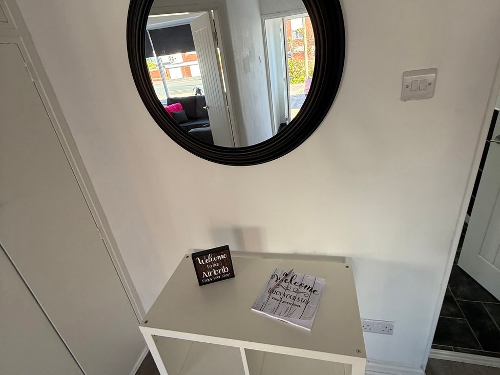 An entrance hall with a table and mirror at Beach Side Bungalow 