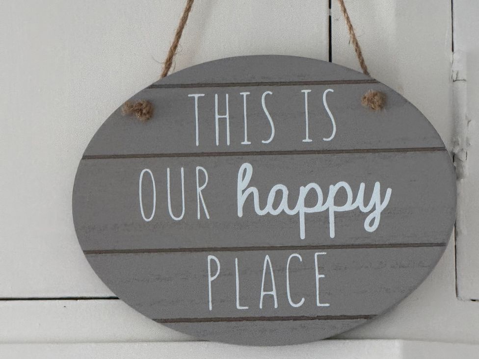 A sign that reads 'THIS IS OUR happy PLACE'