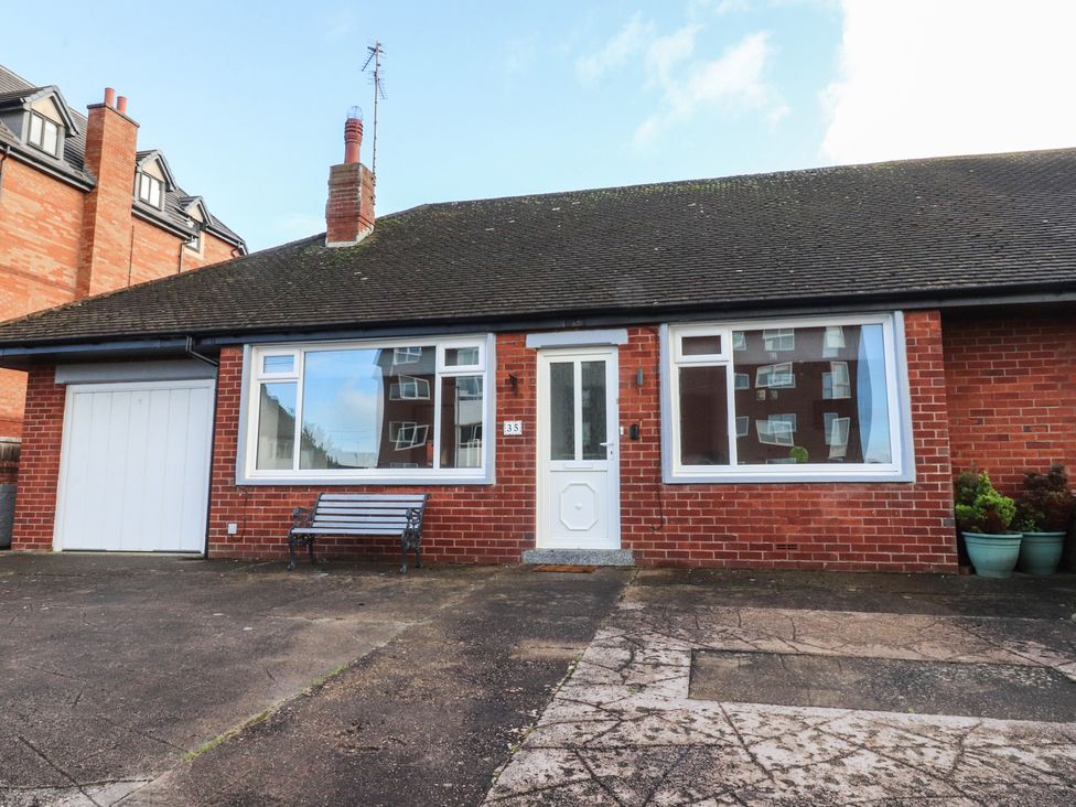 A bungalow with a front porch and garden features at Beach Side Bungalow in Lytham St. Annes