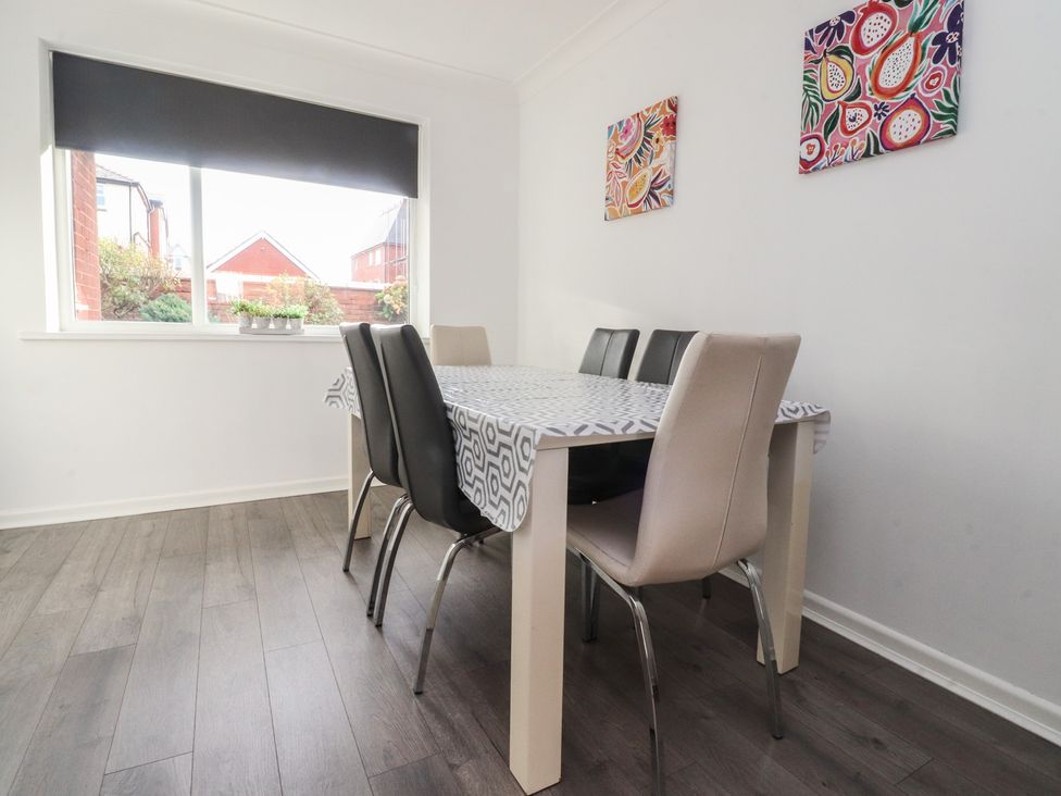A dining room with a table and chairs at Beach Side Bungalow in Lytham St. Annes