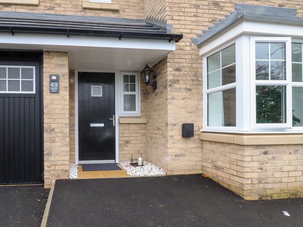 An entrance with a black door and window at 49 Mellings Place