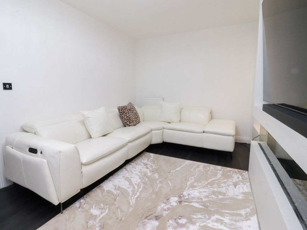 A living room with a sofa and rug at 49 Mellings Place