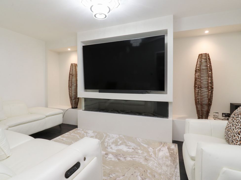 A living room with a television and sofa at 49 Mellings Place