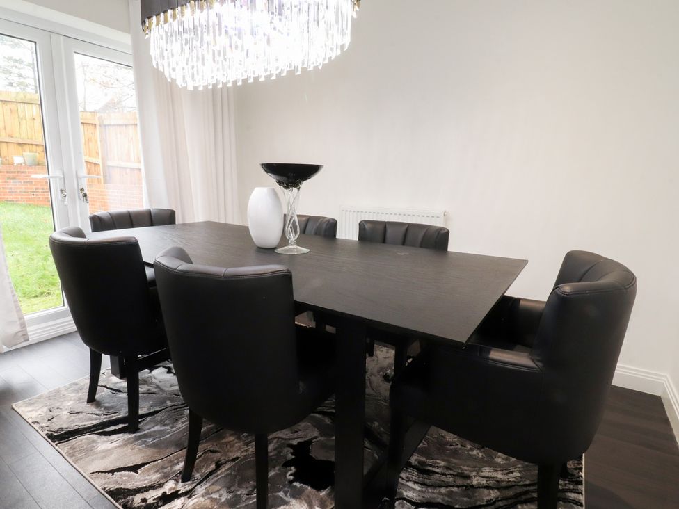 A dining room with a table and chairs at 49 Mellings Place