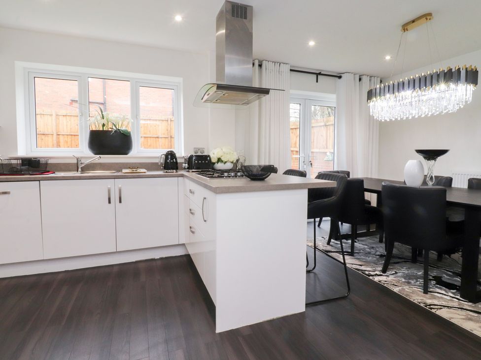 A kitchen with a dining area featuring a countertop and kitchen appliances at 49 Mellings Place