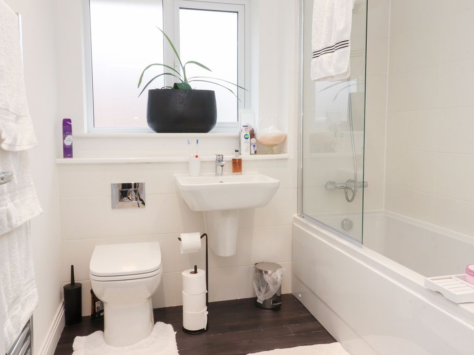 A bathroom with a toilet, sink, and bathtub at 49 Mellings Place
