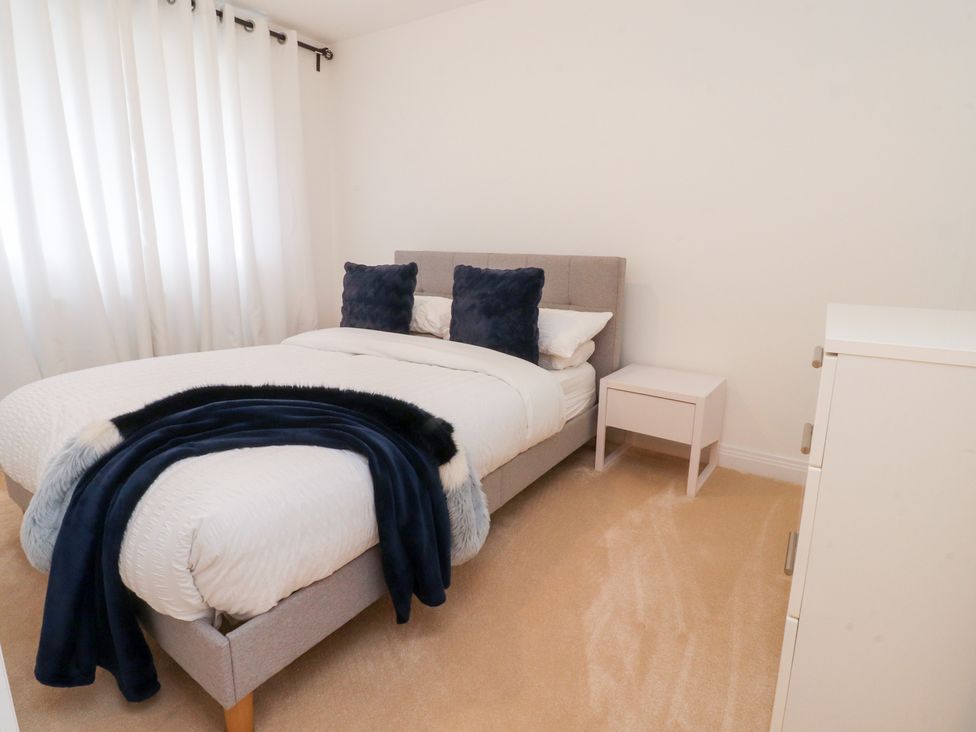 A bedroom with a bed and nightstand at 49 Mellings Place