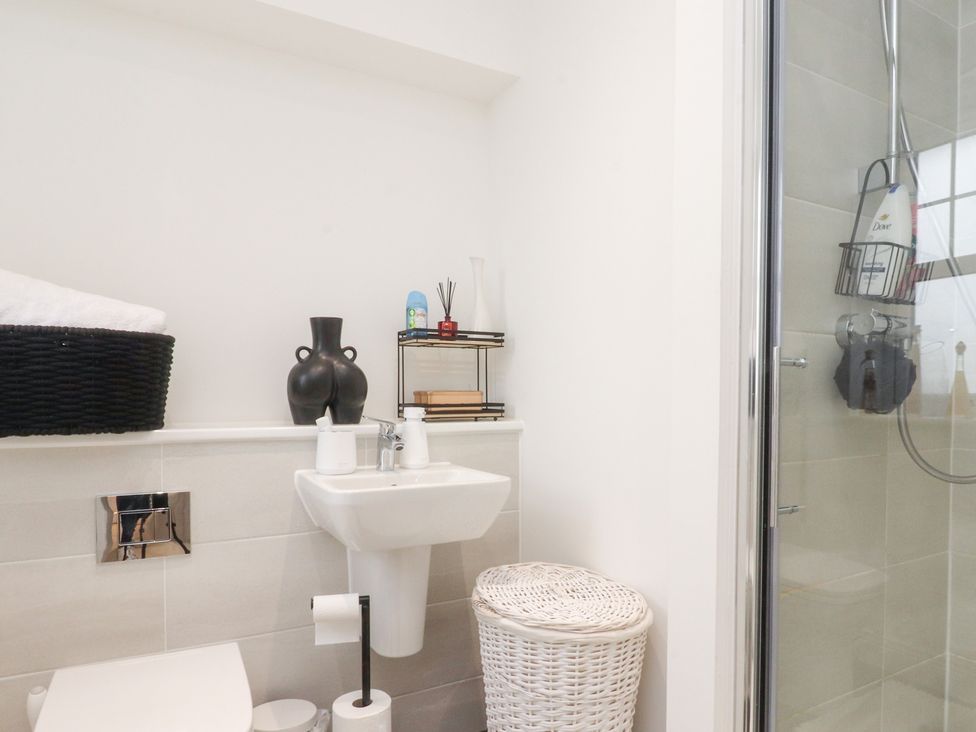 A bathroom with a toilet, sink, and shower at 49 Mellings Place