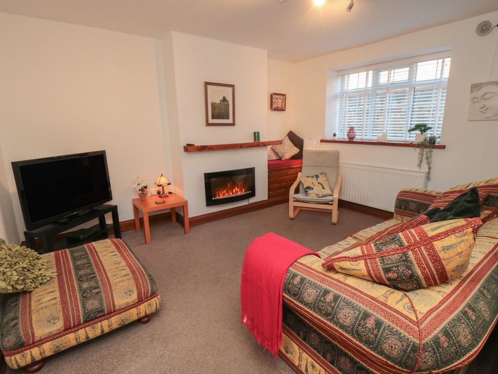 A living room with a television and sofa at Cliffe Cottage in Brotton, North Yorkshire