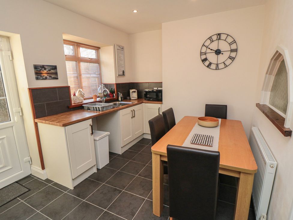 A kitchen with a table and chairs at Cliffe Cottage in Brotton, North Yorkshire