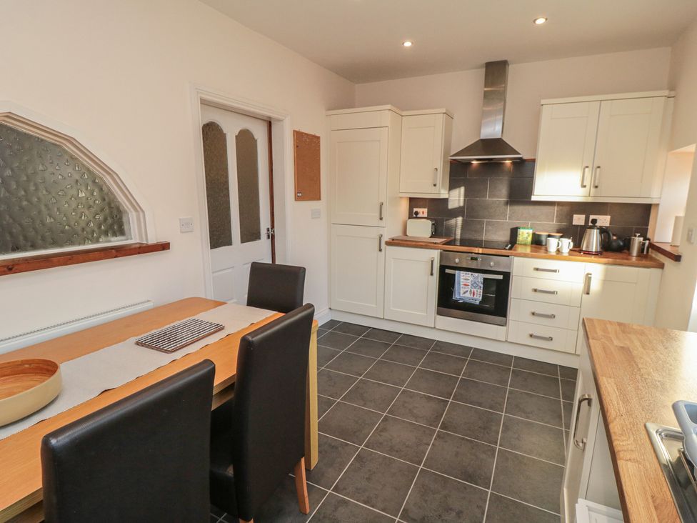 A kitchen with a dining table and chairs at Cliffe Cottage in Brotton, North Yorkshire