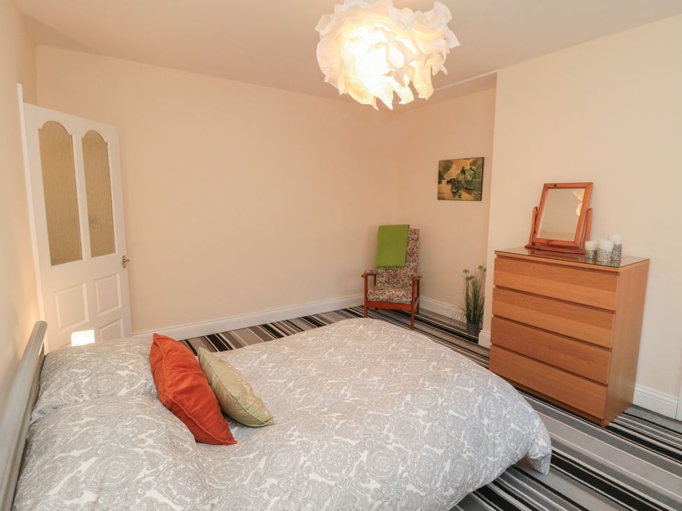 A bedroom with a bed and a dresser at Cliffe Cottage Brotton, North Yorkshire