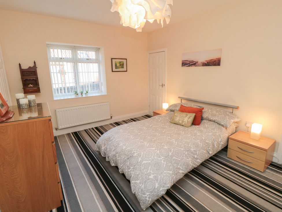 A bedroom with a bed and a window at Cliffe Cottage in Brotton, North Yorkshire