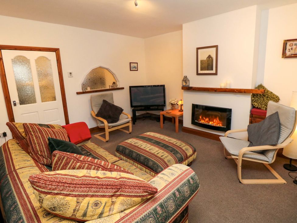 A living room with a sofa and television at Cliffe Cottage, Brotton, North Yorkshire
