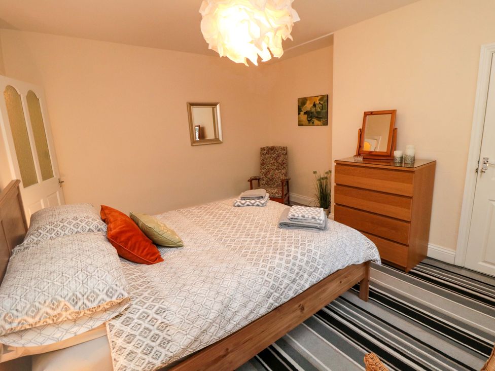 A bedroom with a double bed and a chest of drawers at Cliffe Cottage in Brotton, North Yorkshire