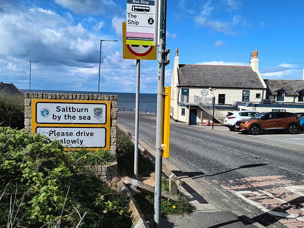 A bus stop and a sign near the sea at Cliffe Cottage Brotton, North Yorkshire