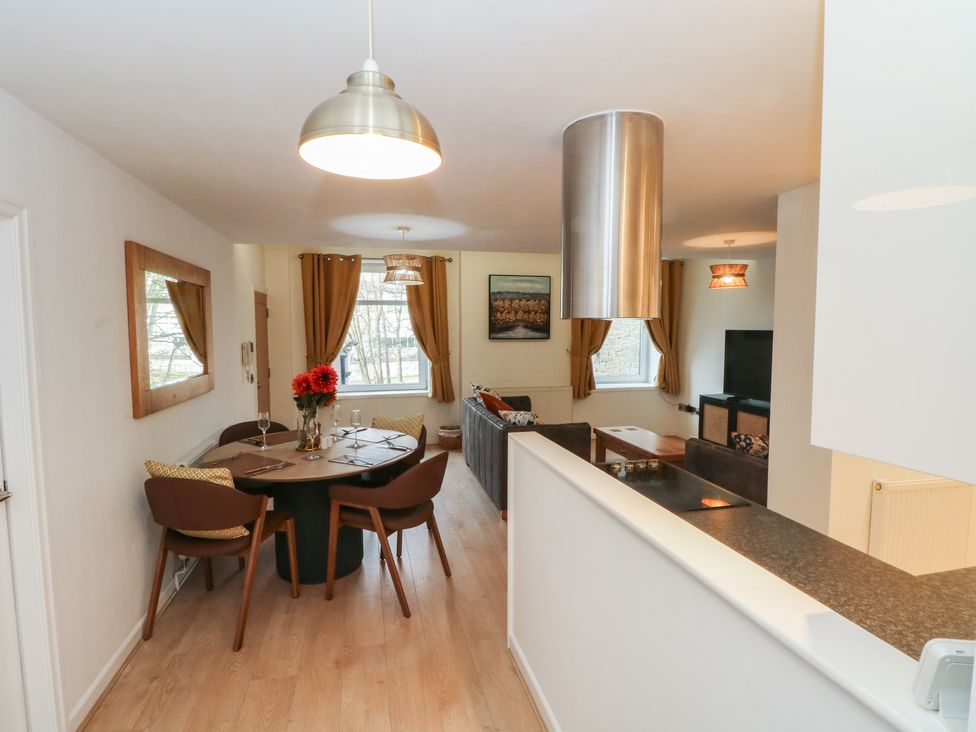 A dining area with a table and chairs at 32A Bank Street in Rossendale