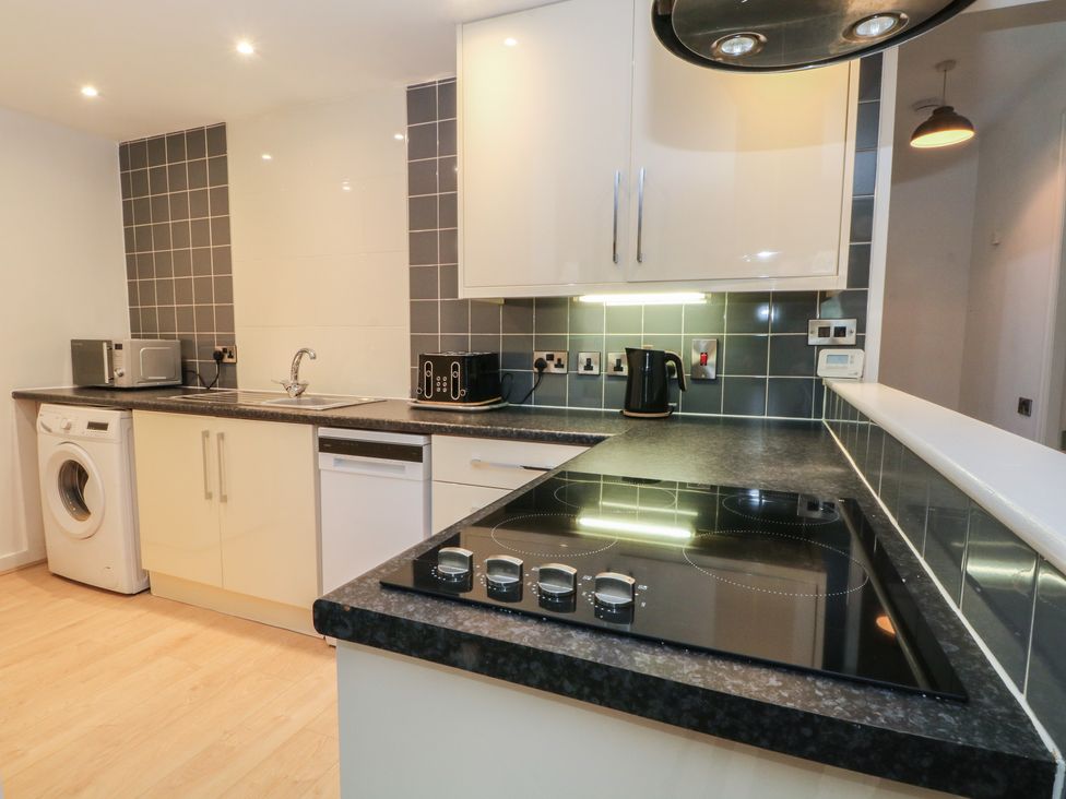 A kitchen with appliances and countertops at 32A Bank Street Rossendale