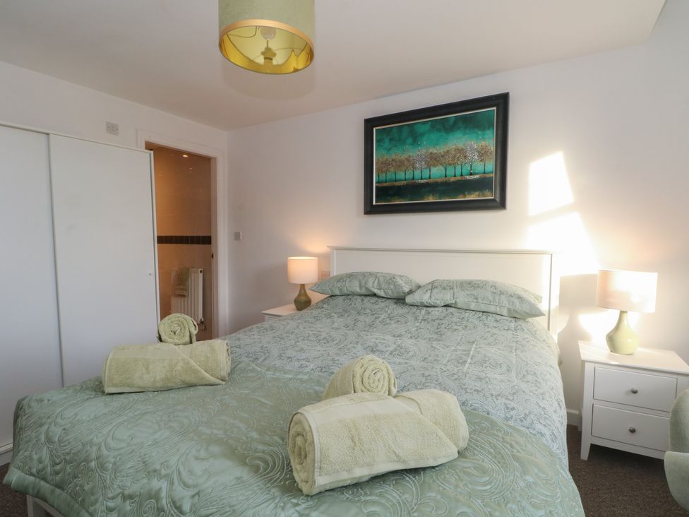 A bedroom with a bed and lamps at 32A Bank Street in Rossendale