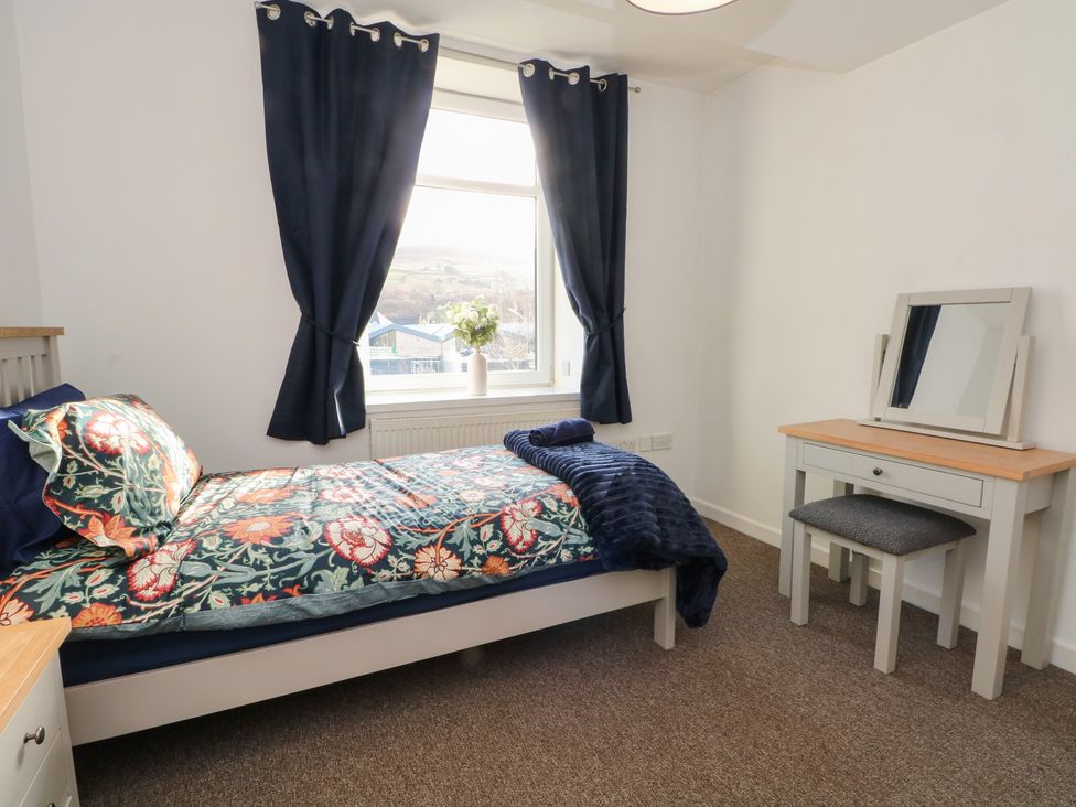 A bedroom with a bed and desk at 32A Bank Street, Rossendale