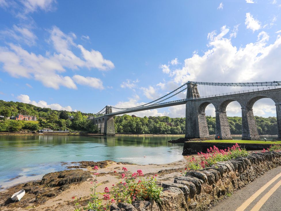 A bridge over water with flowers along the road at 4 Brynteg Terrace Menai Bridge