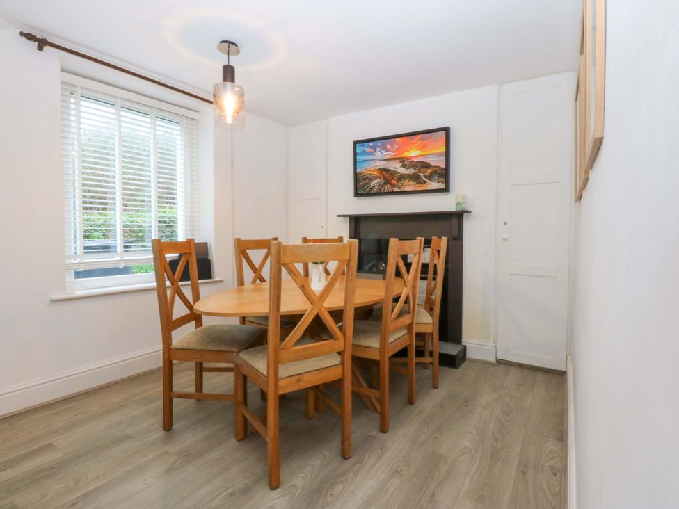 A dining room with a table and chairs at 4 Brynteg Terrace Menai Bridge