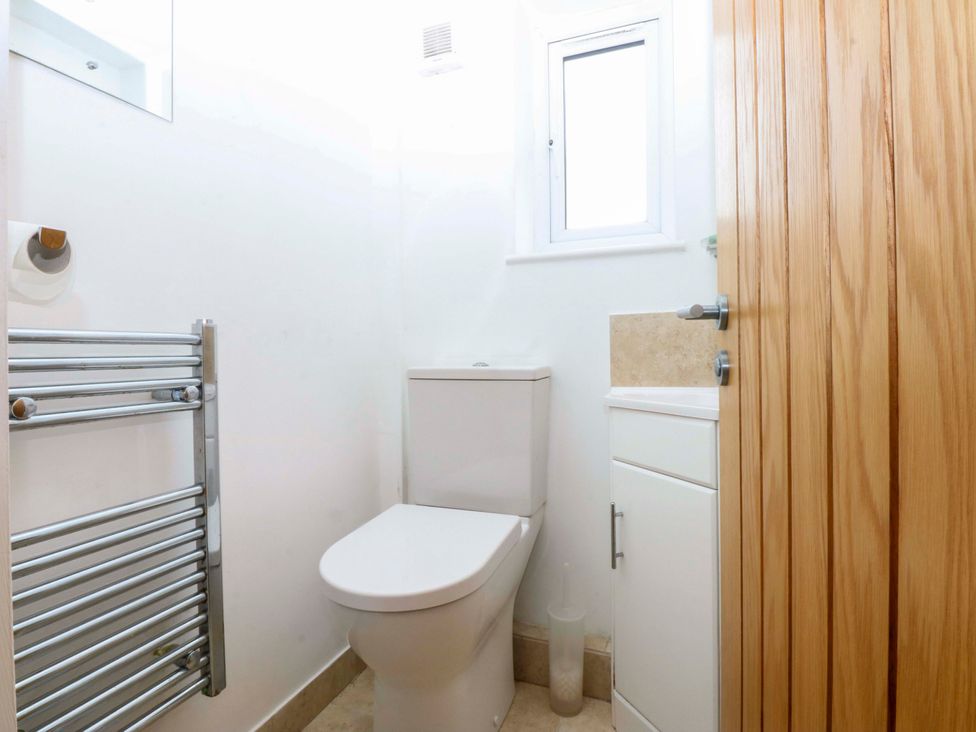 A bathroom with a toilet and sink at 4 Brynteg Terrace in Menai Bridge