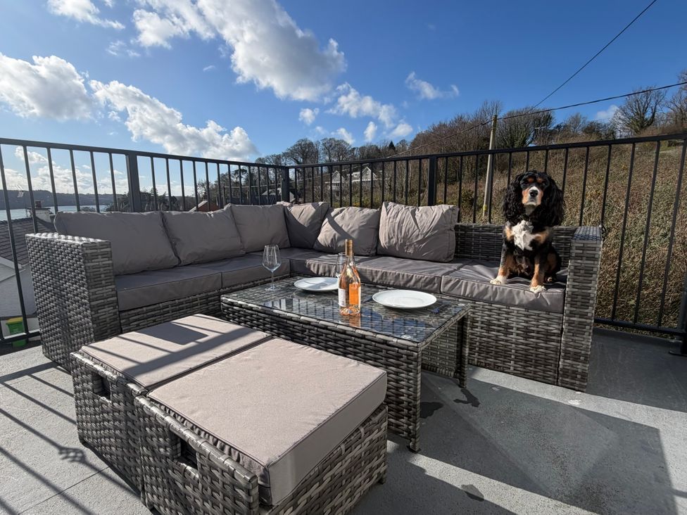 A terrace with seating and a dog at 4 Brynteg Terrace in Menai Bridge
