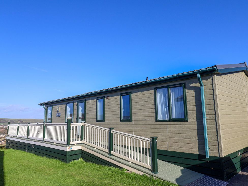 A holiday cabin with a deck and windows at 91 Swanage Coastal Park in Swanage