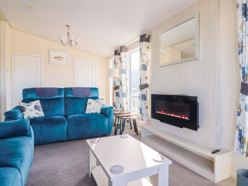 A living room with a sofa and coffee table at 91 Swanage Coastal Park in Swanage