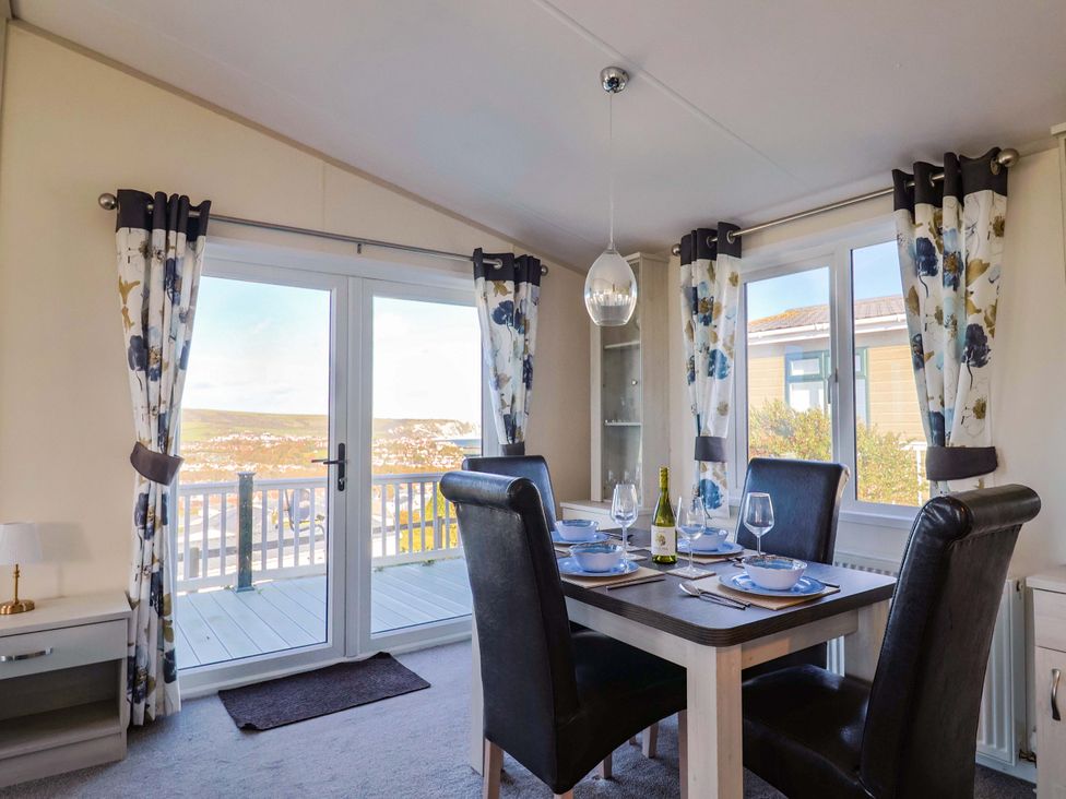 A dining room with a table set for a meal at 91 Swanage Coastal Park in Swanage