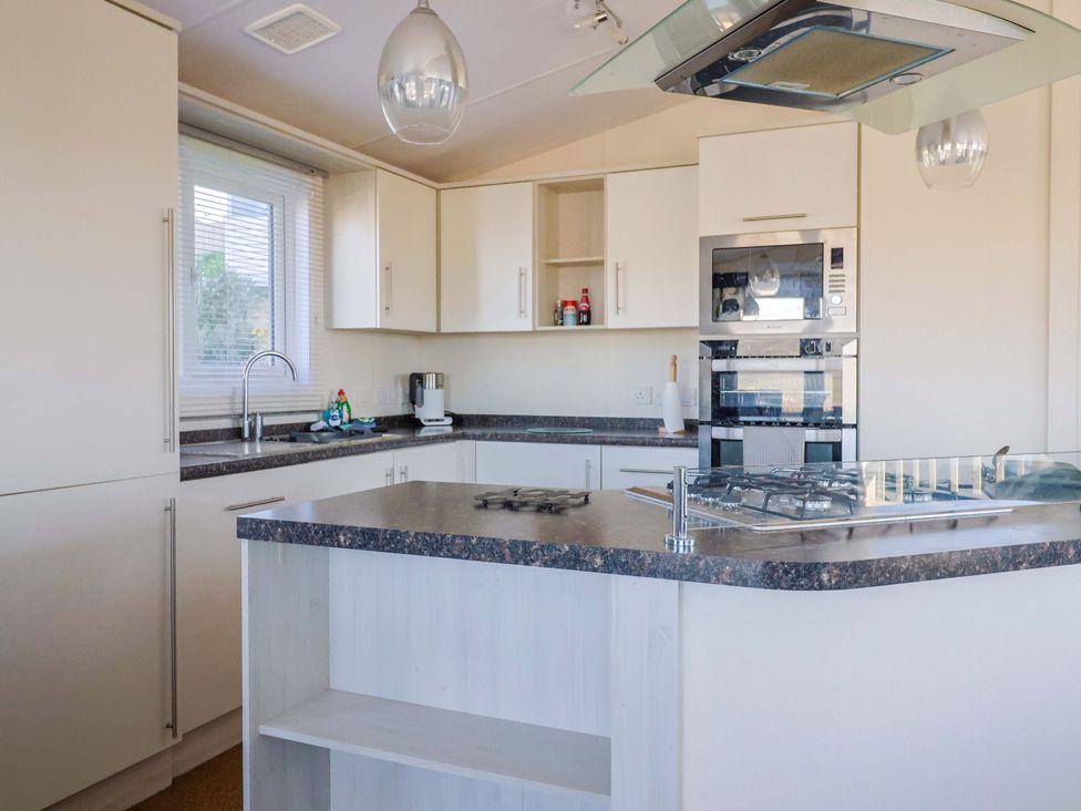 A kitchen with a countertop and appliances at 91 Swanage Coastal Park in Swanage