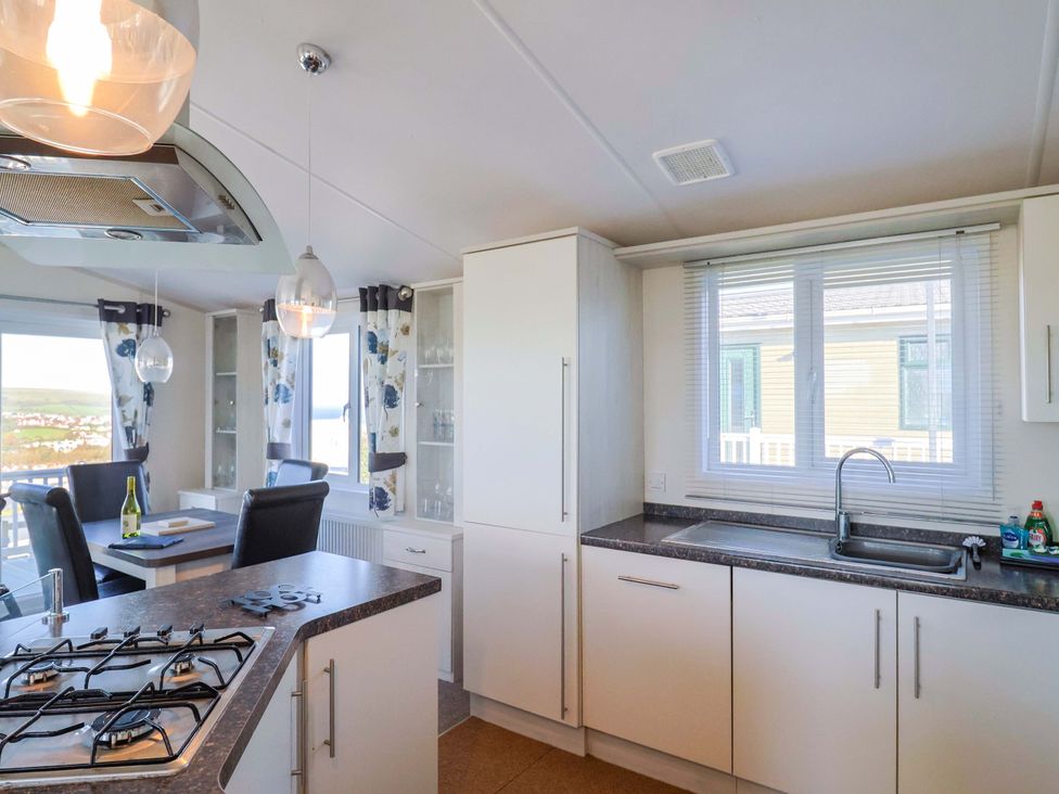 A kitchen with sink and stove at 91 Swanage Coastal Park in Swanage
